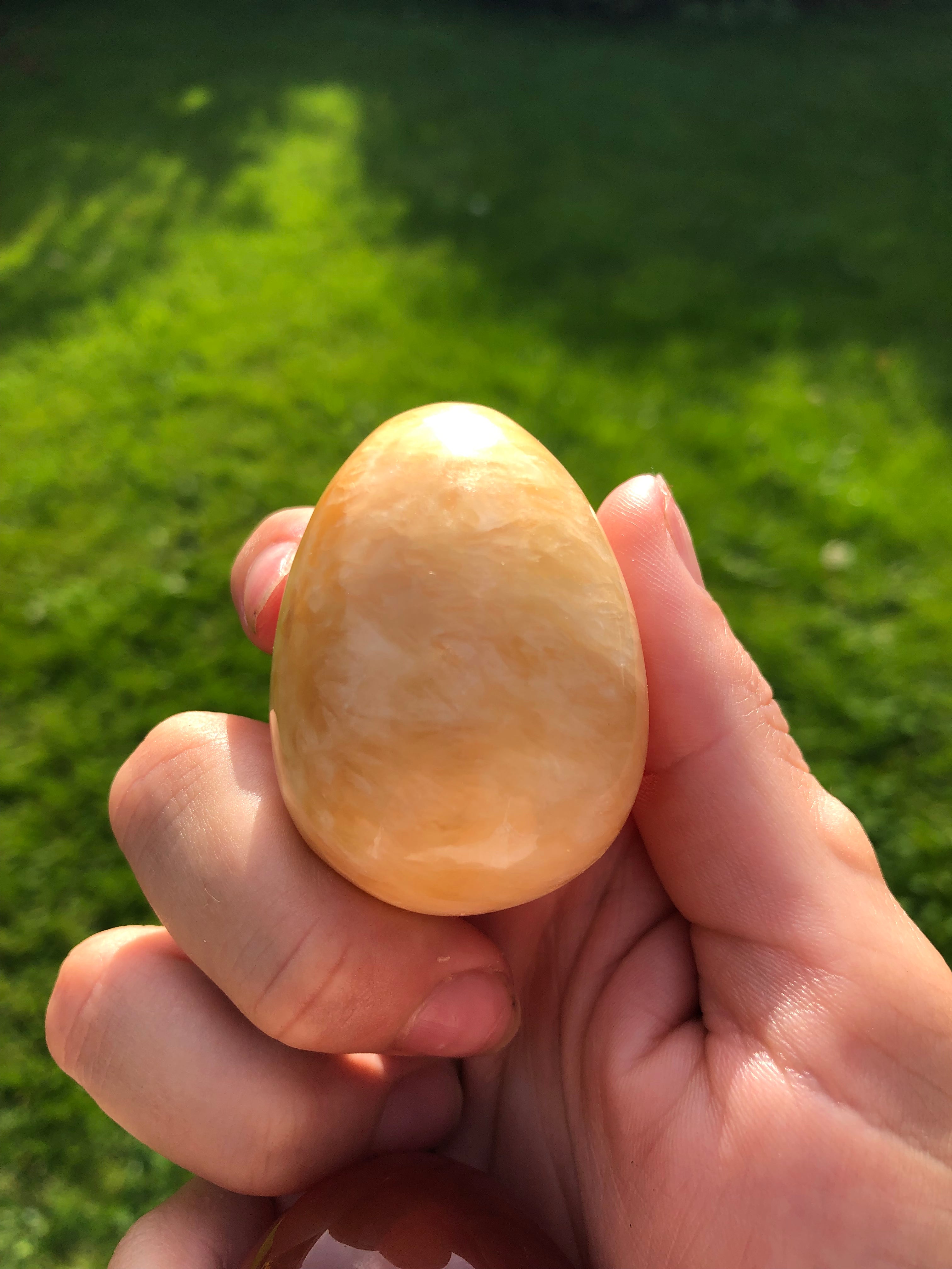 Orange calcite egg encoded with powerful light language