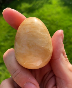 Orange calcite egg encoded with powerful light language